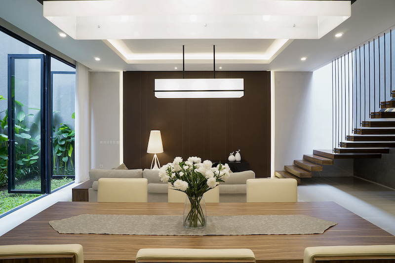 The living space, dining are and the kitchen share the same open plan, with matching light fixtures