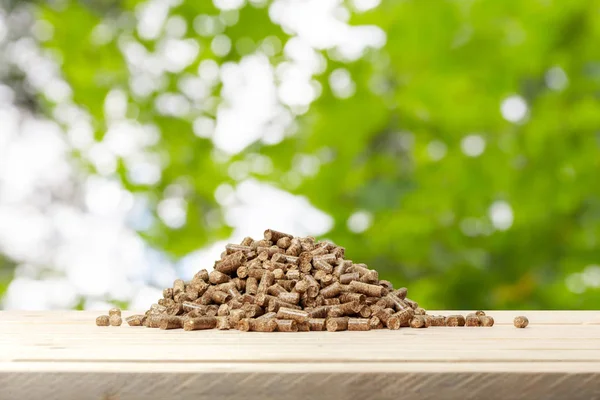 Wood Pellets Green Background Biofuels — стоковое фото