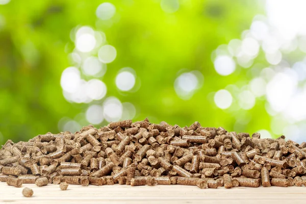 Wood Pellets Green Background Biofuels — стоковое фото